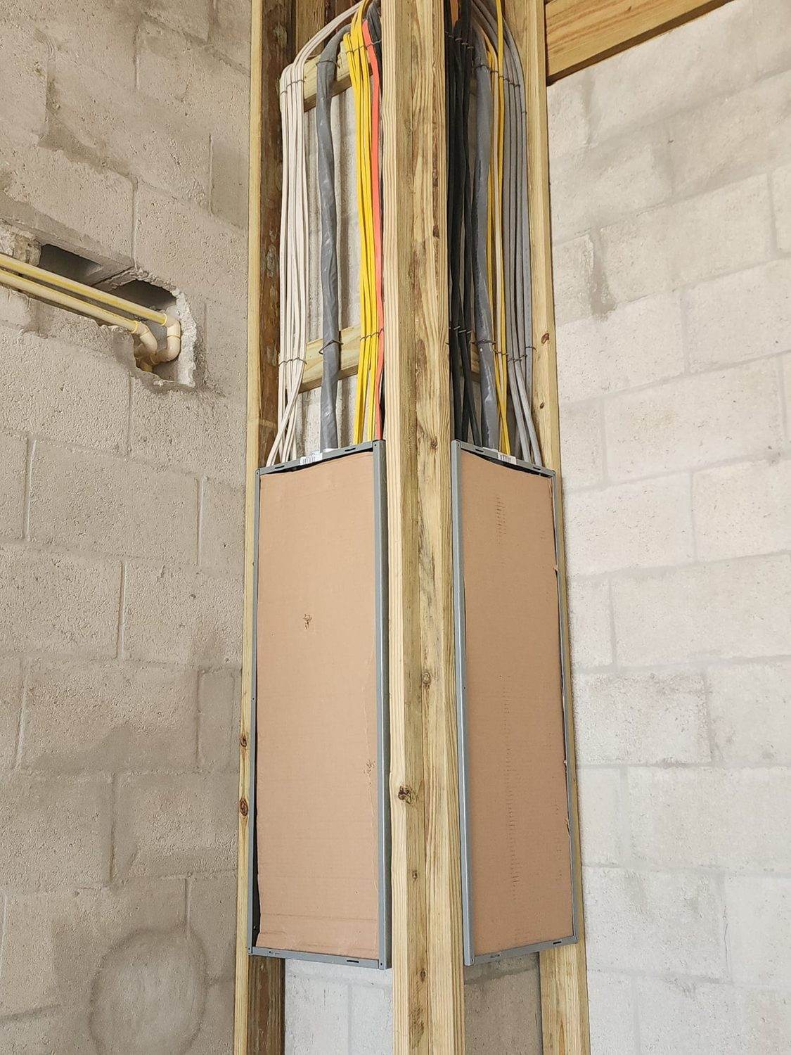 New residential wiring run cleanly through an open wall cavity during a rewire
